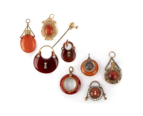 A group of eight Georgian carnelian pendants, early 19th century, comprising: two pendants designed as a padlocks, the larger
