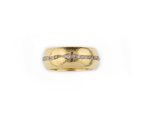 An unusual diamond, ruby and enamel ring, second half 19th century, the wide gold band with a hammered finish, centring on a 