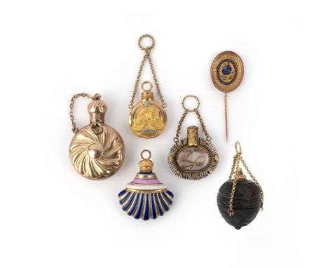 A collection of six charms, 19th century, comprising: four scent bottles, one in gold, one in gold and turquoise, one with a 