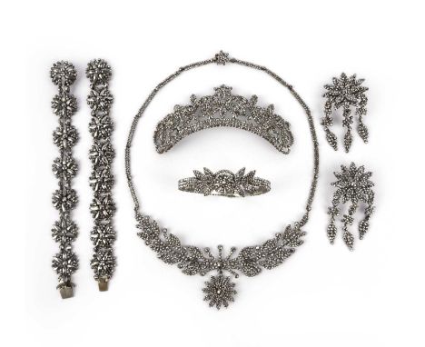 A suite of cut steel jewels, 19th century, comprising: a hair ornament, length 11cm; a pair of earrings of floral tassel desi
