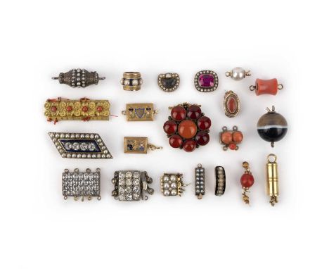 λ A collection of clasps, 19th century, comprising: sixteen clasps, including two set with colourless pastes; five clasps set