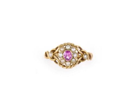 A seed pearl and ruby ring, late 19th century, composed of coiled gold wire and chain linking, centring on a cluster set with