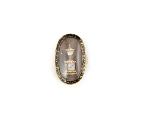 λ A Georgian mourning ring, circa 1789, designed as an oval glazed compartment containing a Neoclassical funerary urn initial