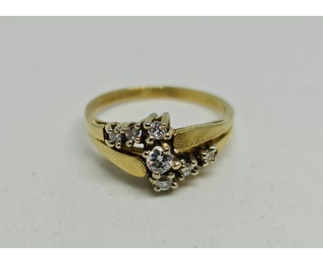A diamond ring, set with graduating round brilliant cut diamonds, total diamond weight approx. 0.26ct, in cross over design, 