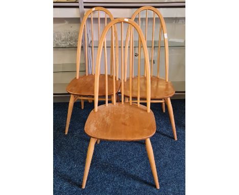 Three Ercol stick back dining chairs.
