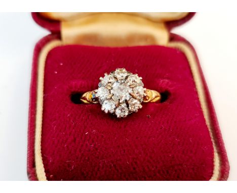 A diamond flower cluster ring, set with nine old cut diamonds, total diamond weight approx. 0.80ct, stamped 18ct, ring size J
