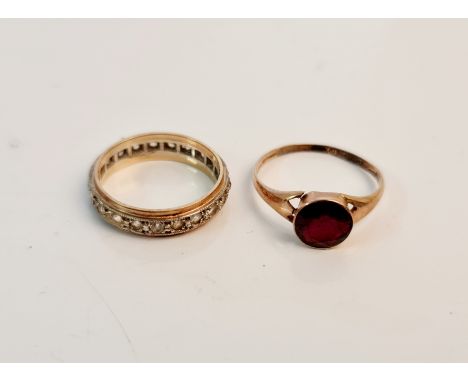 A hallmarked 9ct yellow gold single stone garnet set ring, ring size O (mis-shapen), with a stamped 9ct eternity ring, ring s