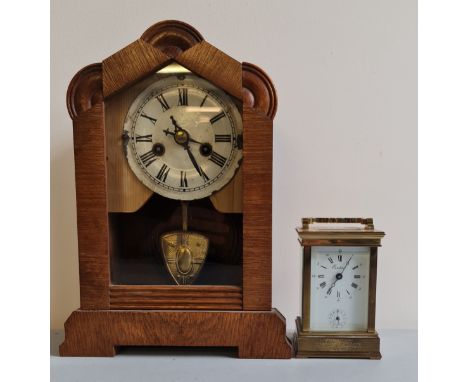 A brass Eurotime carriage clock together with pine mantle clock.