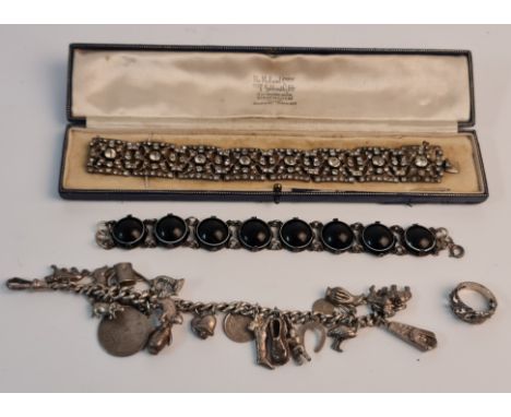 A collection of silver jewellery to include, a charm bracelet with approx. 22 various charms, a link bracelet of 8 black ston