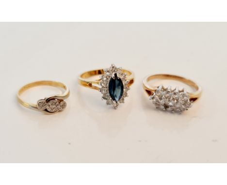 A marked 18ct PLAT three stone diamond ring, ring size K, a yellow metal gem set cluster ring, ring size P 1/2, and a yellow 