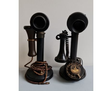 Two black stick telephones.