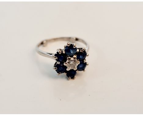 A sapphire and diamond seven stone cluster ring, assessed as 18ct, ring size K