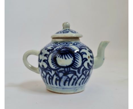 A 19th century Chinese blue and white teapot flower and leaf with spiral to rim design height 10,5 cm.