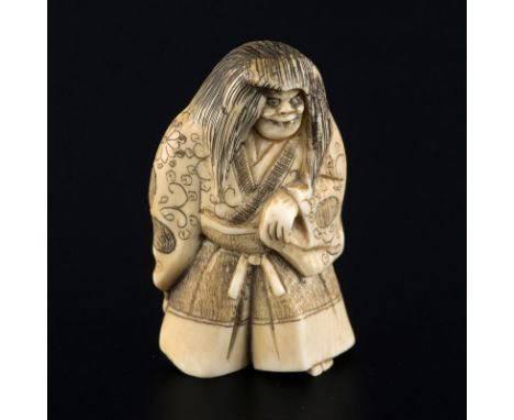 Netsuke en ivoire représentant un danseur de Nô ,dans le rôle d'un démon, Japon, époque Meiji, le danseur tenant le bâton des