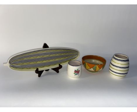 A Clarice Cliff Bizarre patterned bowl, 15cm diameter, together with three pieces of Poole pottery including a cucumber dish