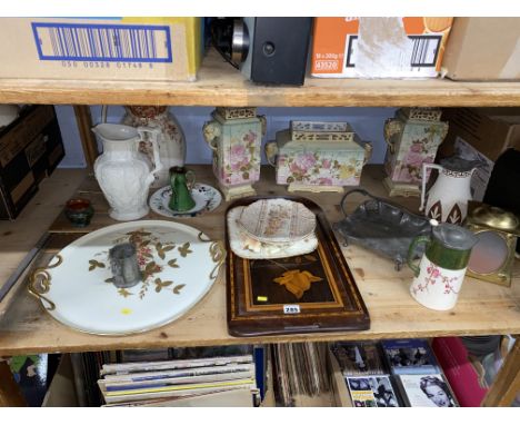 A shelf of assorted ceramics including an Aesthetic period garniture, with elephant handles, Watcombe, Argos and Arts and Cra