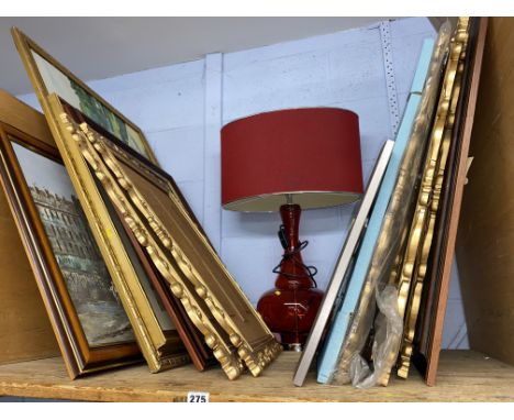 Shelf of pictures, various and a red lamp