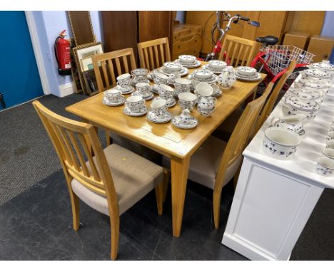 A light oak extending dining table and six chairs