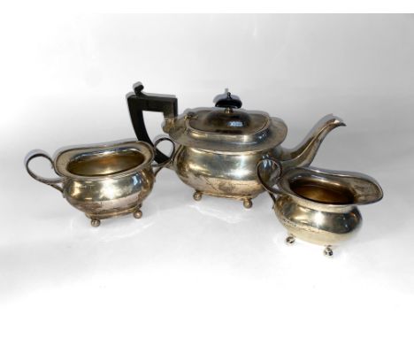 A silver three piece tea service, hallmarked for Henry Matthews of Birmingham and comprising tea pot, sucrier and cream jug