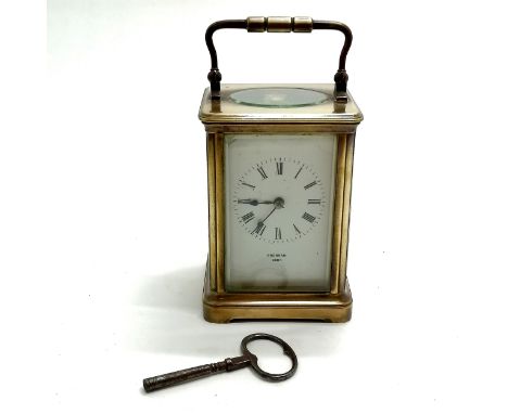 Antique brass carriage clock marked Brennan Cork to porcelain dial - 12cm high x 9cm x 8cm ~ has key and running BUT WE CANNO