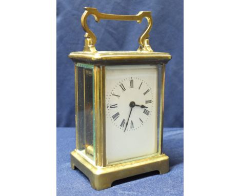 Brass cased carriage clock with white enamel dial and bevelled glass panels (12cm high)