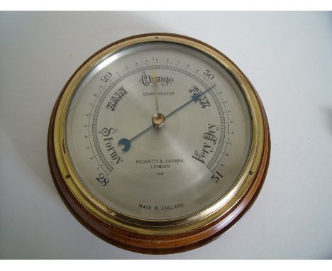 Mahogany cased Negretti & Zambia of London steel faced wall barometer (diameter 22cm) with original receipt of sale  