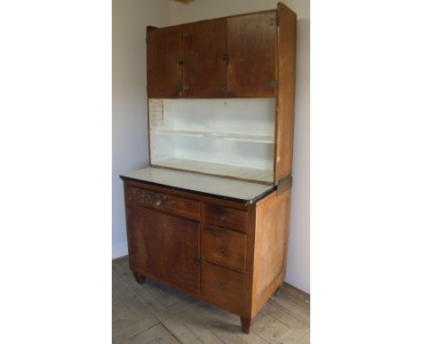 Mid 20th C combination kitchen unit with three upper cupboard doors above two tier open centre and enamel sliding top, above 