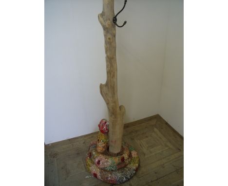 An unusual modern art hat and coat stand sculpture with central wooden column with mosaic snake base 