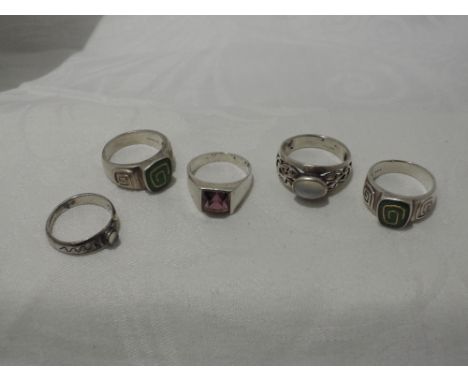 Five white metal dress rings stamped 925 of varios designs including moonstone, green enamel etc
