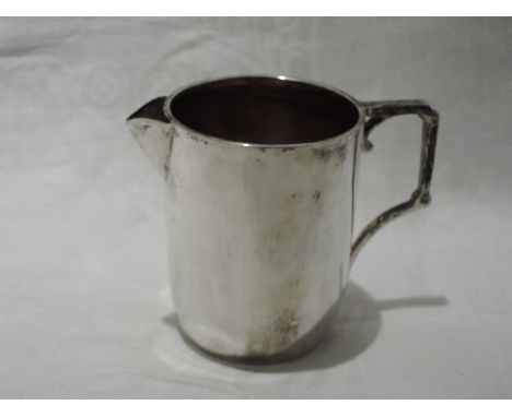 A silver cream jug of plain form having architectural style handle, London 1912, Mappin &amp; Webb