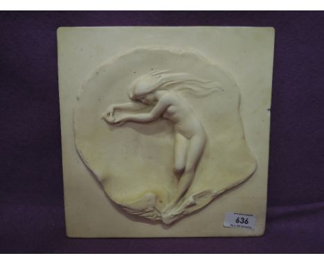 A vintage plaster plaque depicting naked lady holding her pearl in oyster shell, signed Emmilie Hasse, 1917