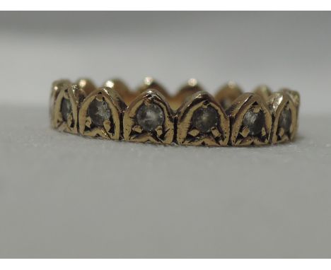 A yellow metal eternity ring stamped 9ct of moulded heart form having cubic zirconia decoration, size K 