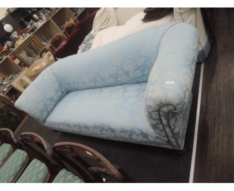 A Victorian sofa having blue pattern upholstery and turned ebonized legs