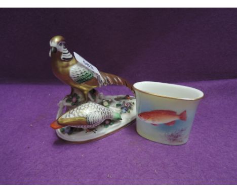 A Royal Worcester spill vase having fish decoration by Badhan and a ceramic figure modelled as Pheasants