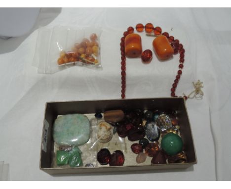A selection of gemstones including jade, amber, cameos etcA pair drill holes to each straight size
