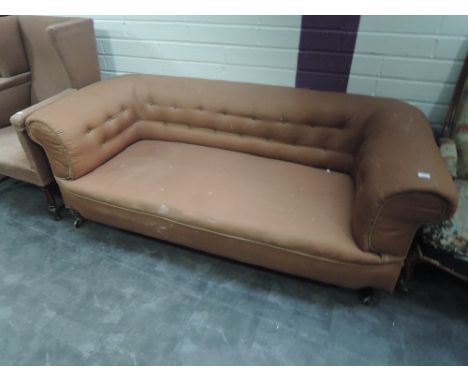 A Victorian sofa having brown upholstery and turned legs