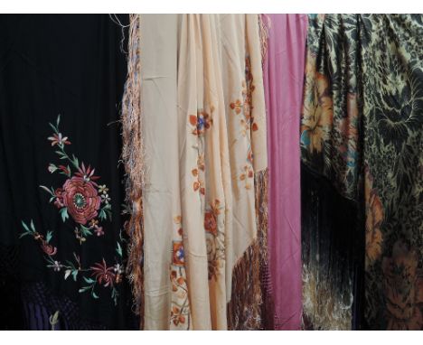 Four early 20th century shawls having extensive fringing to all, some displaying beautiful embroidery others having metallic 