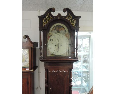 An early 19th century mahogany longcase clock having swan neck, pillar and painted hood containing painted and moonphase dial