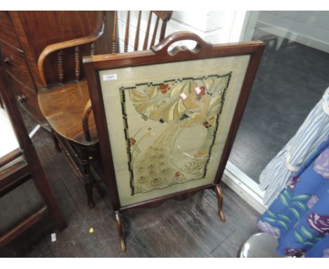 A late 19th century mahogany frame firescreen having Art Nouveau silkwork inset