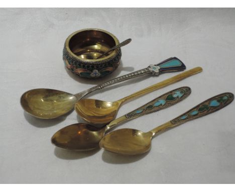 A Russian silver gilt and enamel salt with spoon, and four similar teaspoons, all bearing Russian marks