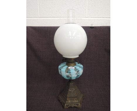 A late Victorian oil lamp having striated blue glass reservoir on cast baseCONDITION REPORTRubbing to glass reservoir, slight
