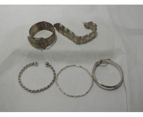 Five HM silver and white metal bangles and bracelets including 7 bar gate, slave bangle etc