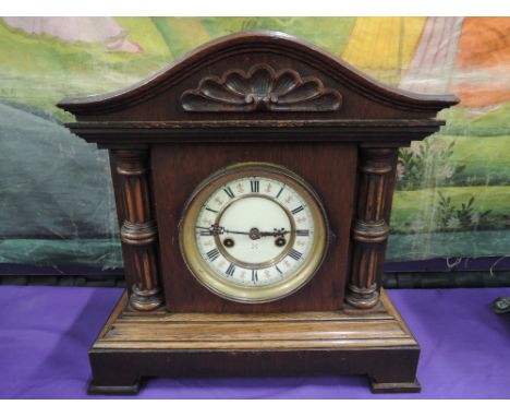 A late Victorian oak mantel clock of architectural design