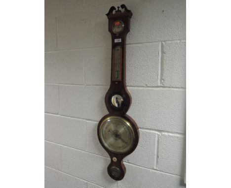 A 19th century mahogany wheel barometer having humidity and thermometer scales labelled for G. Cetti, Buckingham