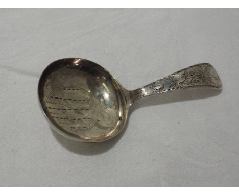 A Georgian silver caddy spoon having extensive brightcut decoration and bearing monogram to reverse of bowl, Birmingham 1798,