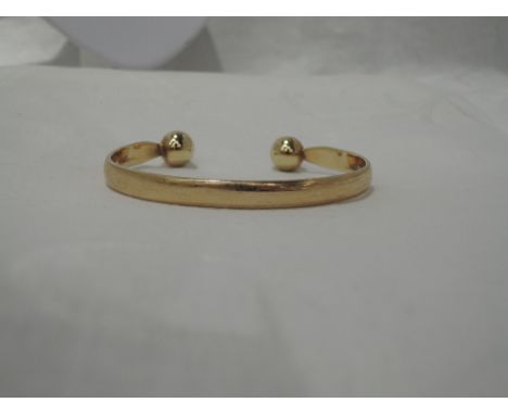 A 9ct gold torque bangle of plain formCONDITION REPORTScratches appear, in used condition, no major defectsTotal Weight 28.5g