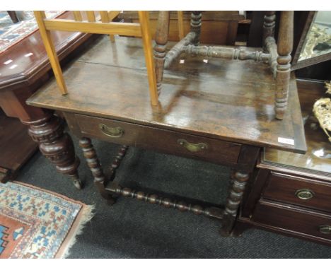A composite 19th and 20th century oak side table in the Jacobean style having frieze drawer and bobbin frame