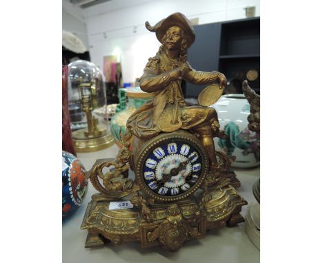A 19th century gilt metal mantel clock of French design having period artist finial and enamel face with striking movement, o