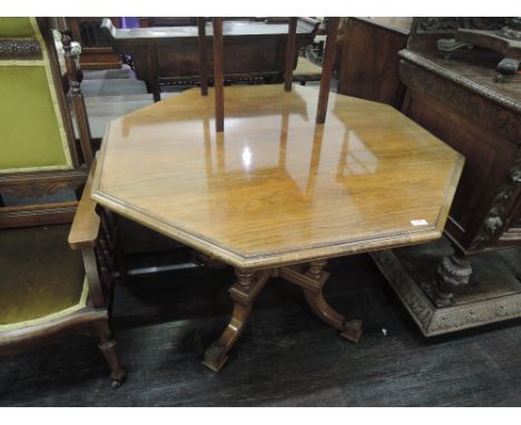 An early Victorian rosewood centre/dining table having octagonal top on quad reeded pillar supports with X frame and foliate 