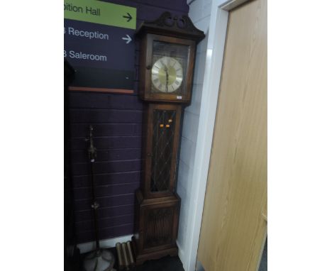 A late 20th century oak longcase West German clock having swan neck with striking movement, Roman numeral/dial and leaded gla